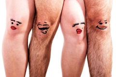 A man's and woman's legs with faces painted on them.