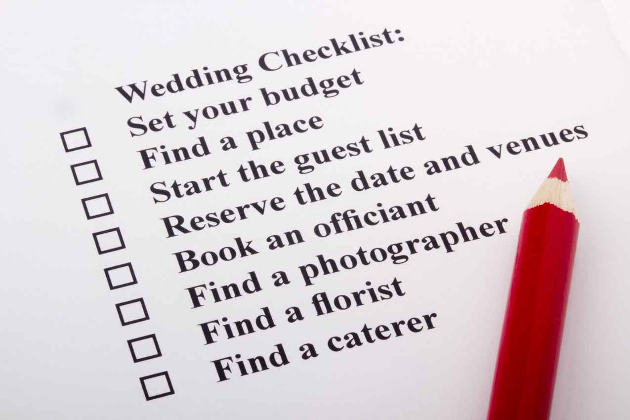 A wedding to-do checklist with a red pencil.