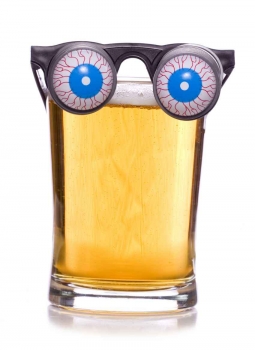 Plastic beer goggles on a glass of beer.
