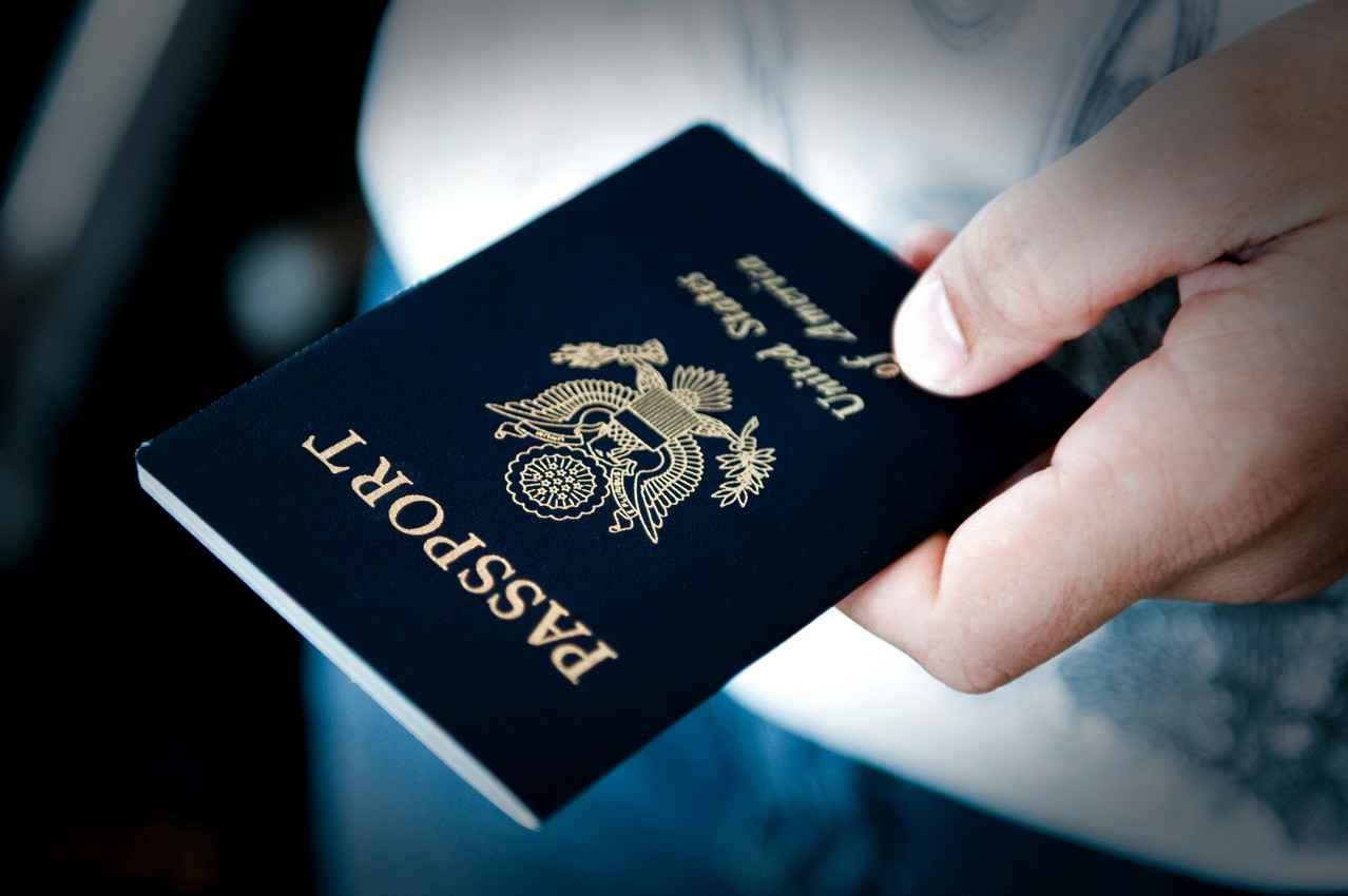 A fat man holding a United States passport.