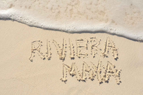 Riviera Maya written in the sand on the beach.