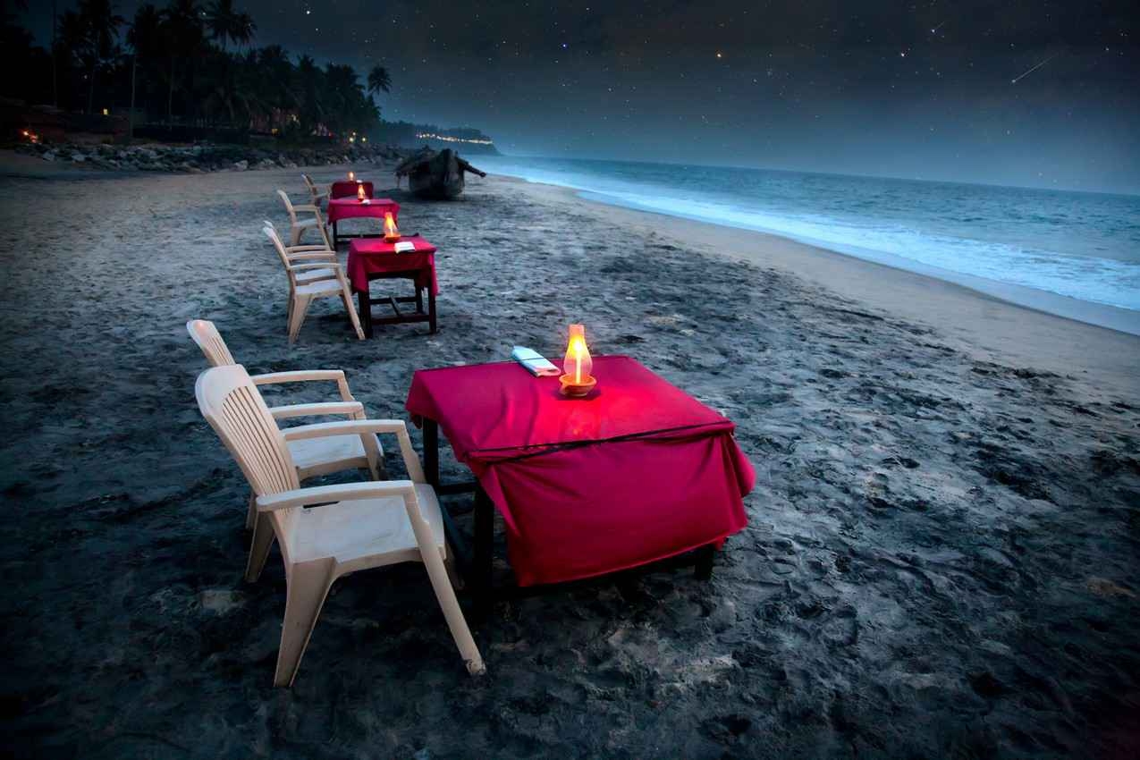 Several candlelit tables that were set up to view the night sky facing the beach.
