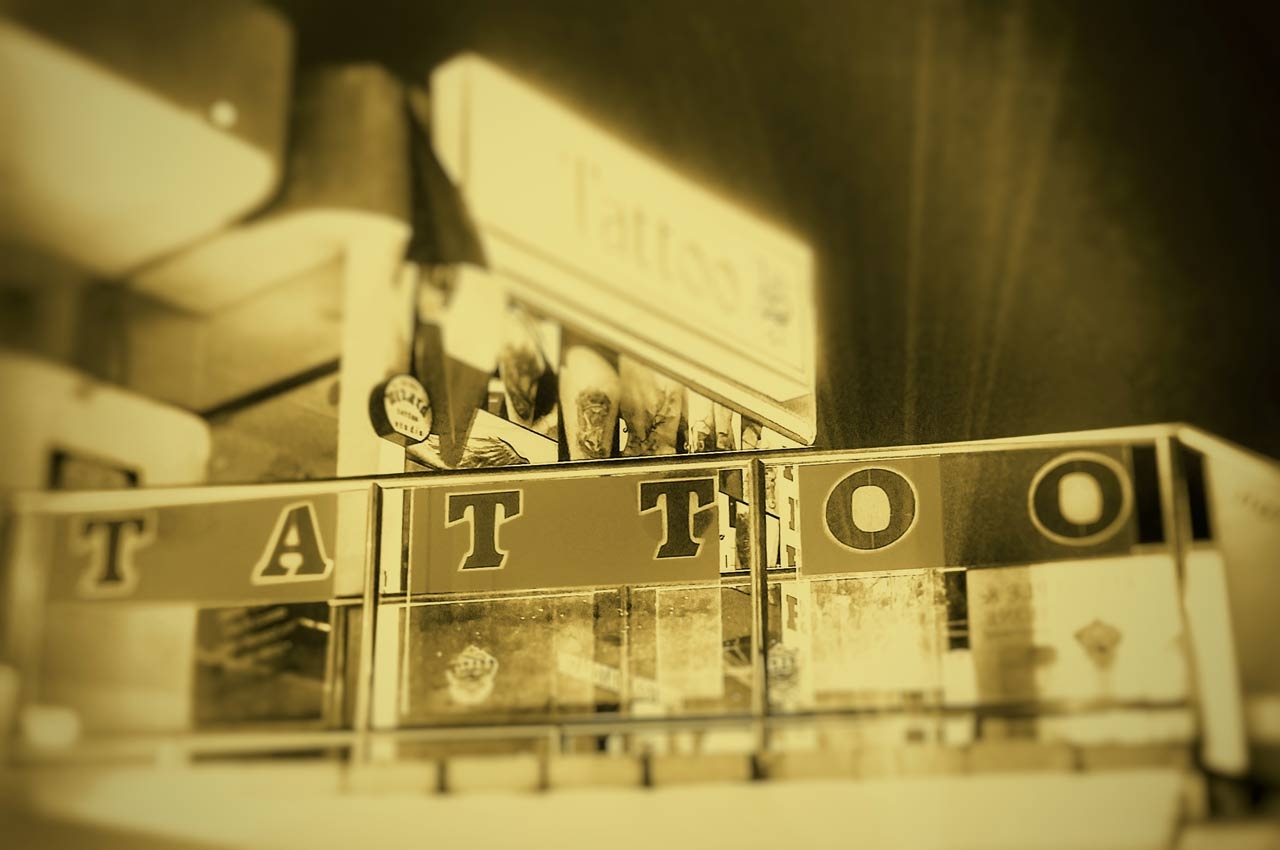 A sign outside a tattoo parlor in Playa Del Carmen that reads "TATTOO" in big letters.