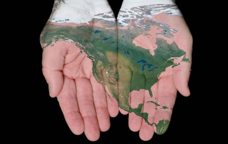 A representation of North America painted onto hands.