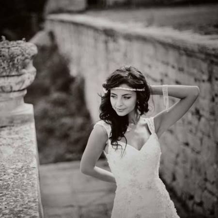 A grayscale picture of a bride near some Mayan ruins.
