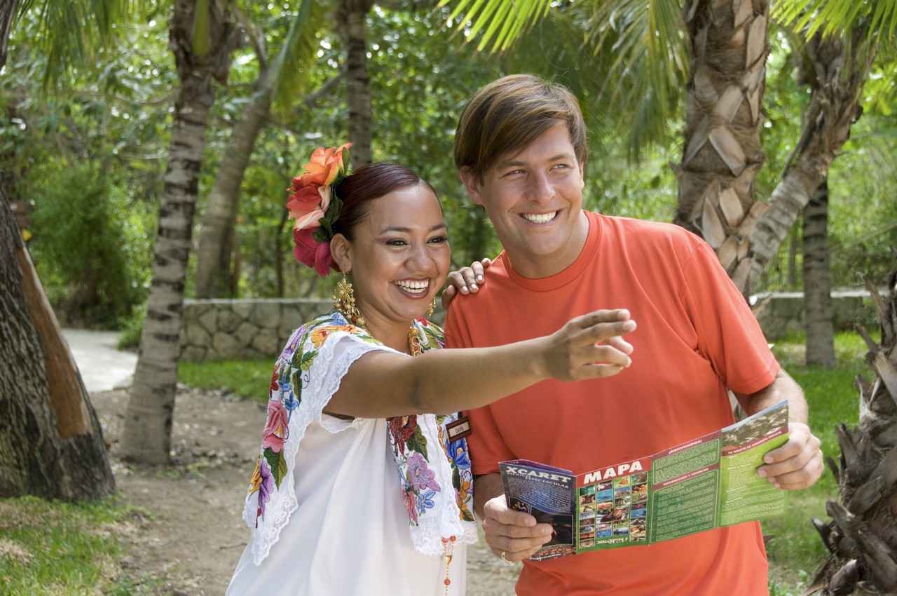 An Xcaret employee pointing a tourist in the right direction.