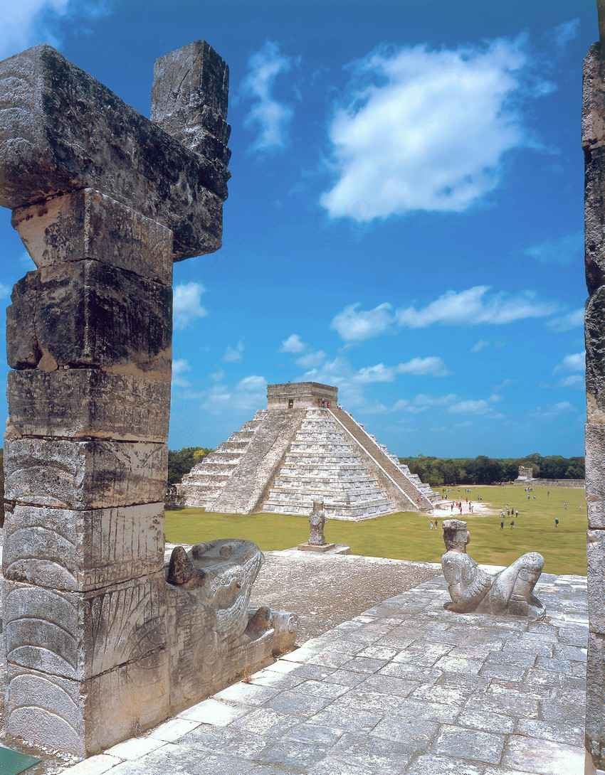 Mayan architecture featuring both a statue and a pyramid.